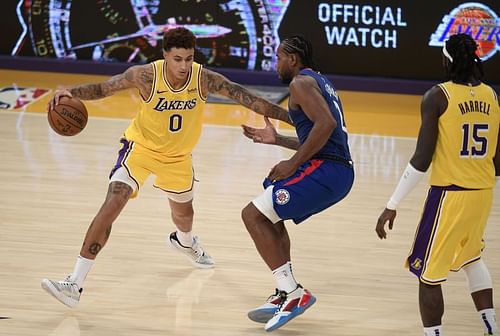 Kyle Kuzma dribbles past Kawhi Leonard