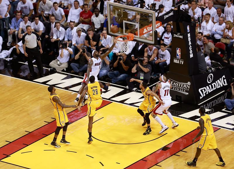LeBron James #6 of the Miami Heat drives to the basket against Paul George in the 2013 ECF.