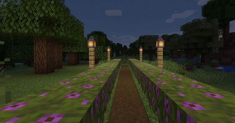 Shown: An Azalea pathway lit up by Lanterns (Image via Minecraft)