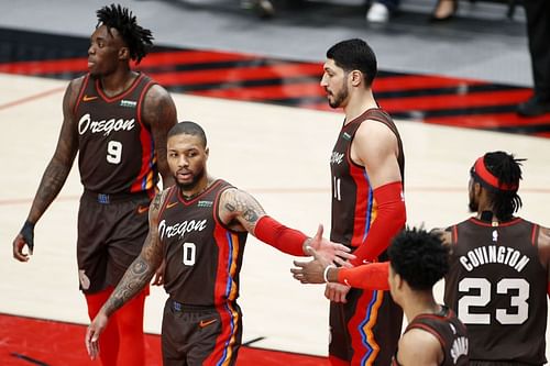 Damian Lillard #0 celebrates with his teammates during a game