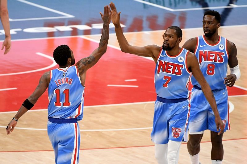 Kyrie Irving #11 and Kevin Durant #7 celebrate after a play