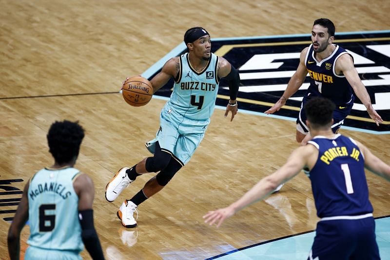 Devonte&#039; Graham #4 dribbles against the Denver Nuggets.