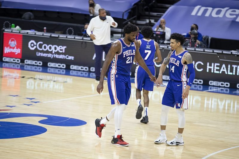 Joel Embiid #21 and Danny Green #14 react against the Miami Heat.