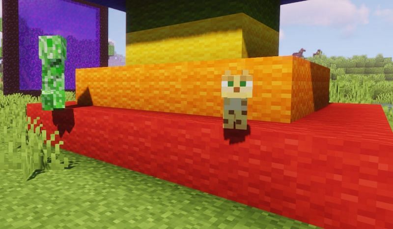 A Creeper booking it away from an unaware Ocelot (Image via Minecraft)