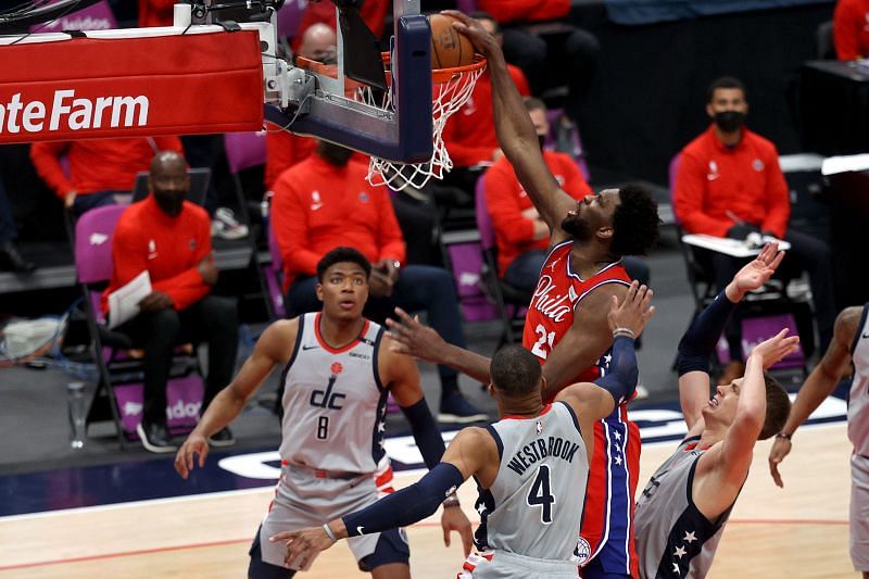 Joel Embiid #21 of the Philadelphia 76ers dunks in front of Rui Hachimura #8 and Russell Westbrook #4 of the Washington Wizards