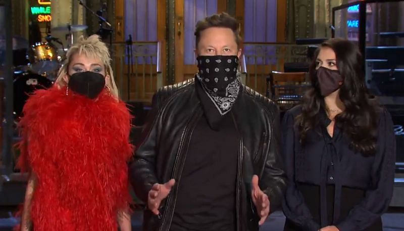 Miley Cyrus and Elon Musk from new SNL promo (Image via NBC&rsquo;s Saturday Night Live)