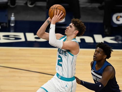 Anthony Edwards (#1) watches as LaMelo Ball (#2) shoots the ball.