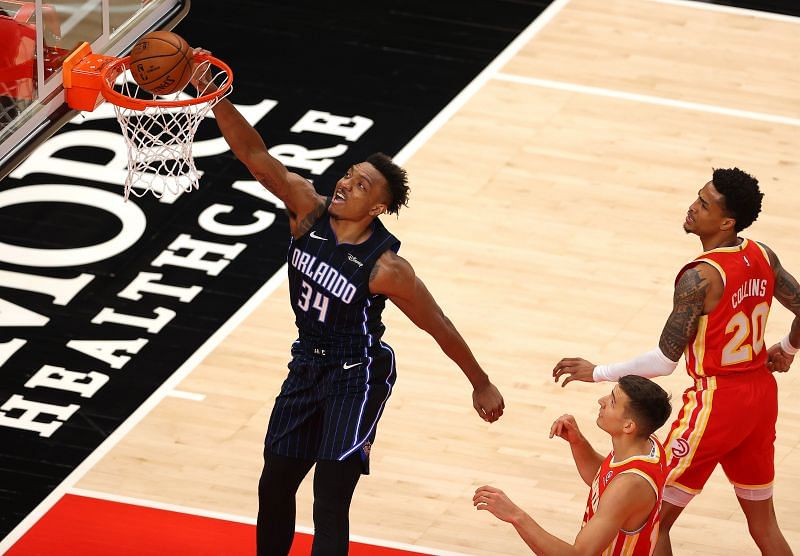 Wendell Carter Jr. #34 dunks the ball against John Collins #20 and Bogdan Bogdanovic #13.