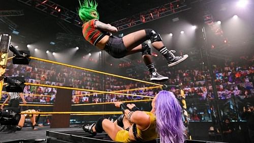 Shotzi Blackheart hitting the senton on Candice LeRae on a ladder