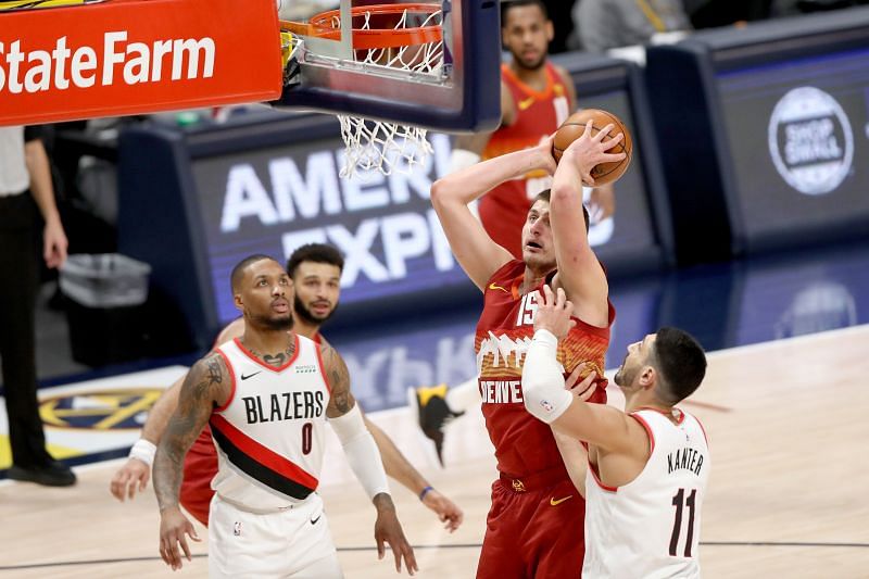 Nikola Jokic of the Denver Nuggets finishes at the rim against the Portland Trail Blazers