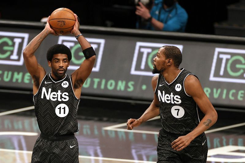 The Brooklyn Nets&#039; Kyrie Irving #11 looks to pass as Kevin Durant #7 looks on