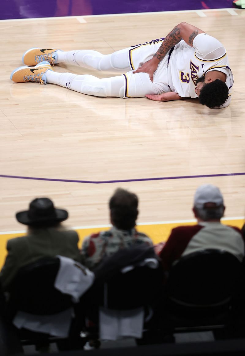 Anthony Davis #3 of the Los Angeles Lakers grabs his thigh after falling during the first half of Game Four