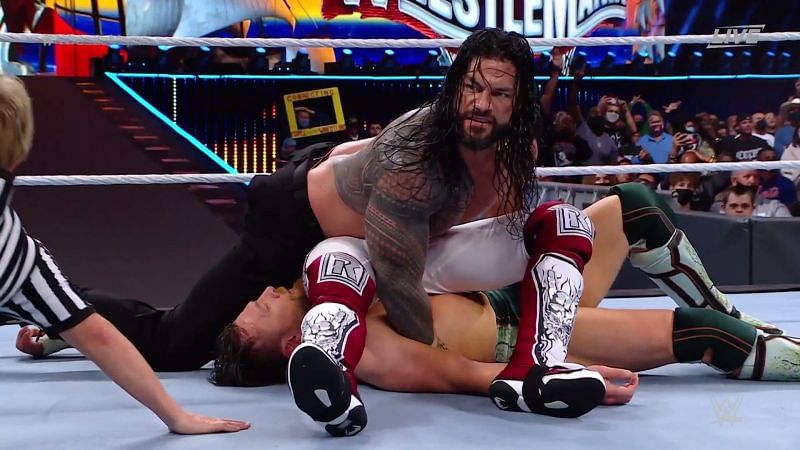 Roman Reigns stacking and pinning Edge and Daniel Bryan