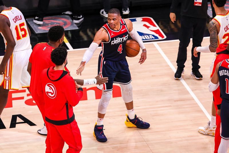 Russell Westbrook #4 is congratulated by Atlanta Hawks players after breaking the NBA record for career triple-doubles