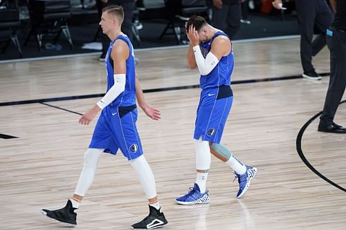 Dallas Mavericks duo Kristaps Porzingis #6 and Luka Doncic #77 leave the court