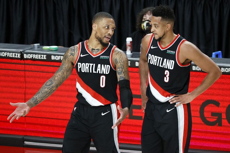 Damian Lillard #0 and CJ McCollum #3 talk during a stoppage in play against the Brooklyn Nets.