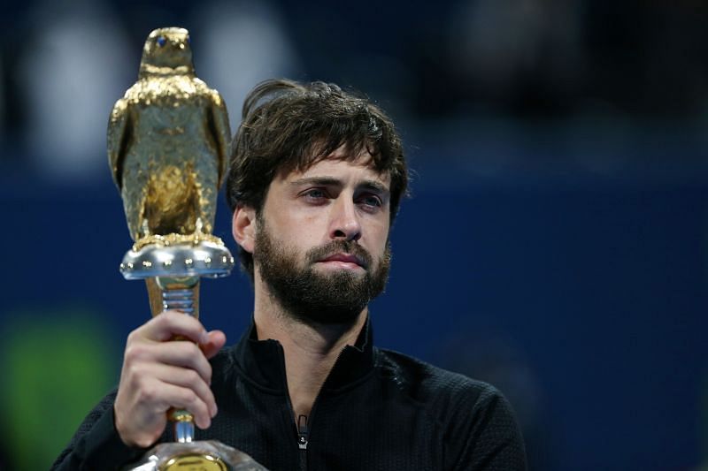 Nikoloz Basilashvili with the 2021 Qatar ExxonMobil Open trophy