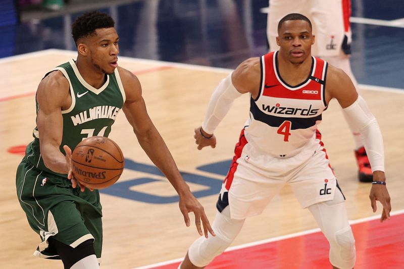 Giannis Antetokounmpo (#34) of the Milwaukee Bucks passes in front of Russell Westbrook (#4) of the Washington Wizards