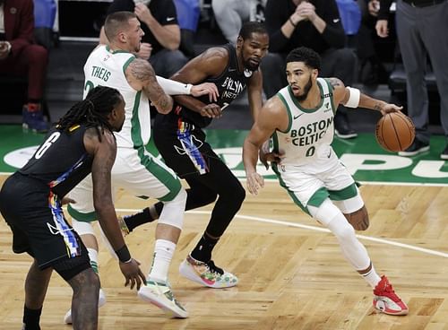 Jayson Tatum #0 of the Boston Celtics drives to the basket against Kevin Durant #7