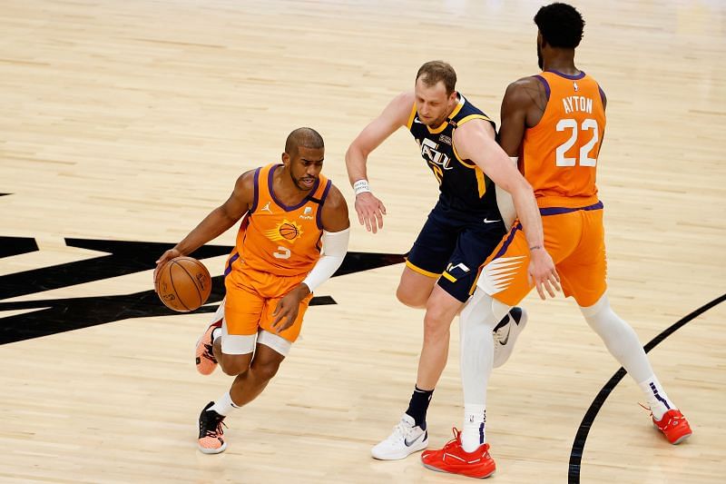 Chris Paul (#3) of the Phoenix Suns drives the ball past Joe Ingles (#2) of the Utah Jazz.