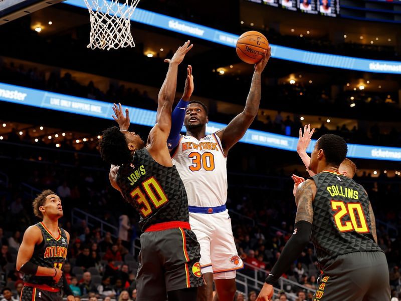 Julius Randle #30 of the New York Knicks attacks the basket against Damian Jones #30 of the Atlanta Hawks