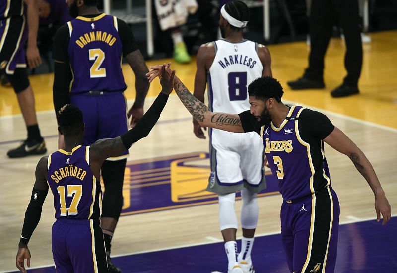 Anthony Davis (#3) is congratulated by his LA Lakers teammate Dennis Schroder (#17).