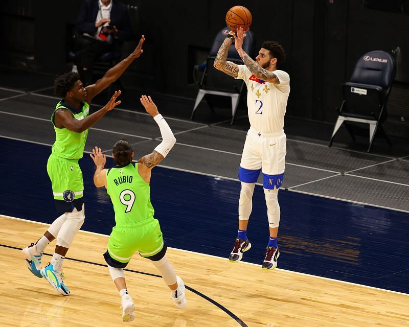 Lonzo Ball #2 shoots the ball over Anthony Edwards #1