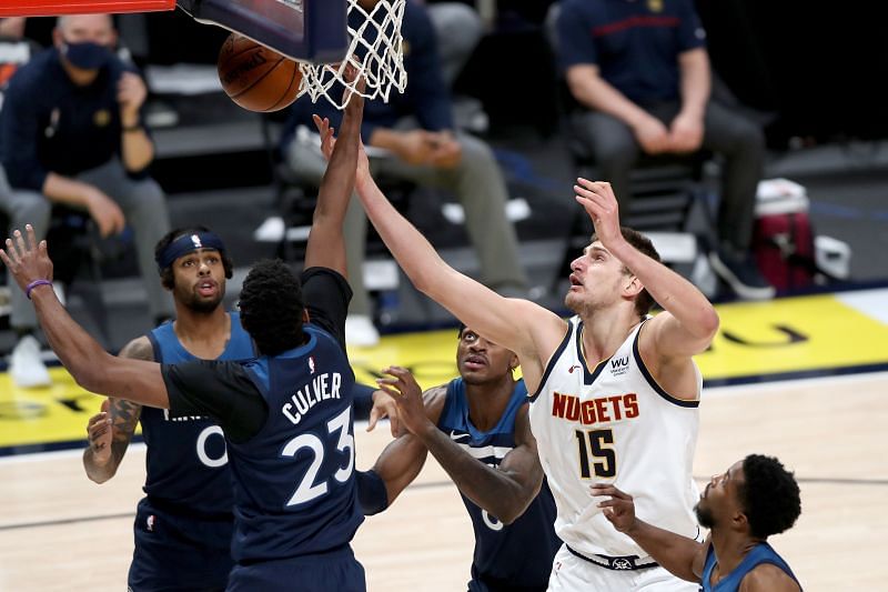 Nikola Jokic #15 fights for a rebound with Jarrett Culver #23