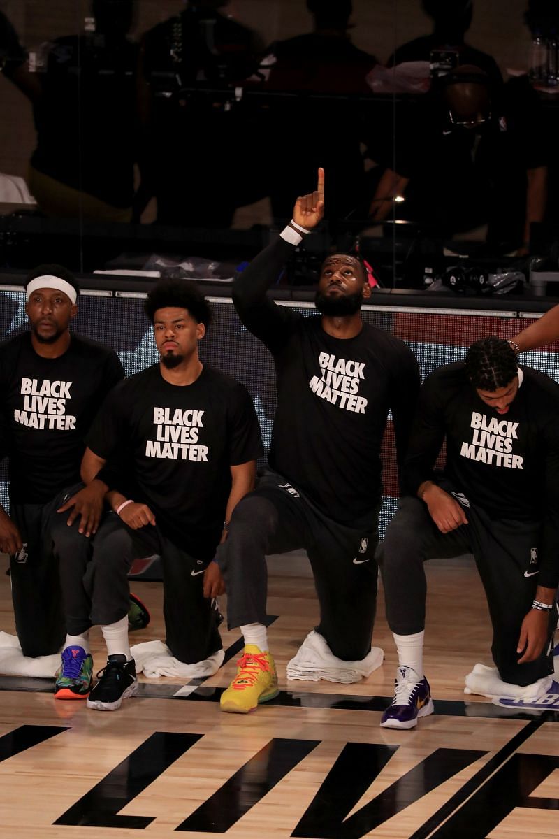 Los Angeles Clippers and Los Angeles Lakers players take a knee during the US national anthem in support of the Black Lives Matter movement