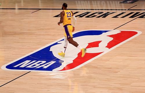 LeBron James #23 of the Los Angeles Lakers runs past the NBA logo