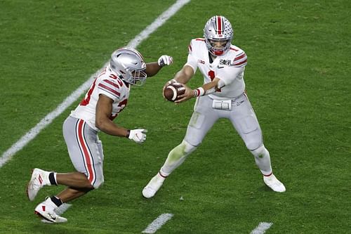 Ohio State quarterback Justin Fields hands off the football during the third quarter of the College Football Playoff National Championship against Alabama on Jan. 11, 2021.