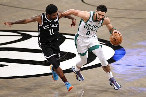 Jayson Tatum drives against Kyrie Irving