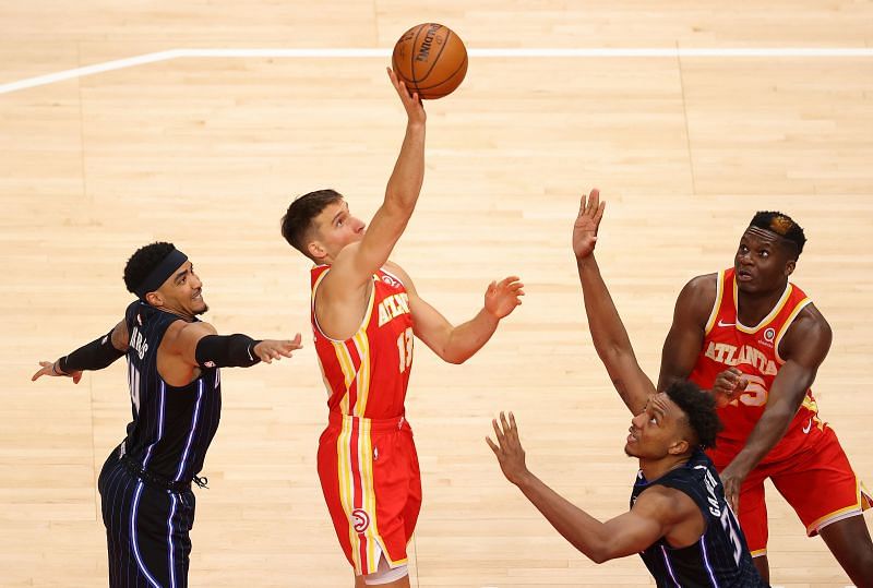 Bogdan Bogdanovic #13 attempts a shot against Gary Harris #14 and Wendell Carter Jr. #34.