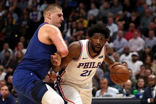 Nikola Jokic #15 of the Denver Nuggets guards Joel Embiid #21 of the Philadelphia 76ers