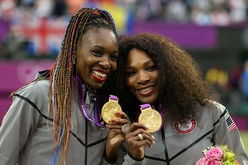 Venus and Serena Williams pose with their gold medals at the 2012 London Olympics