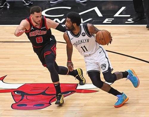 Kyrie Irving #11 drives against Zach LaVine #8