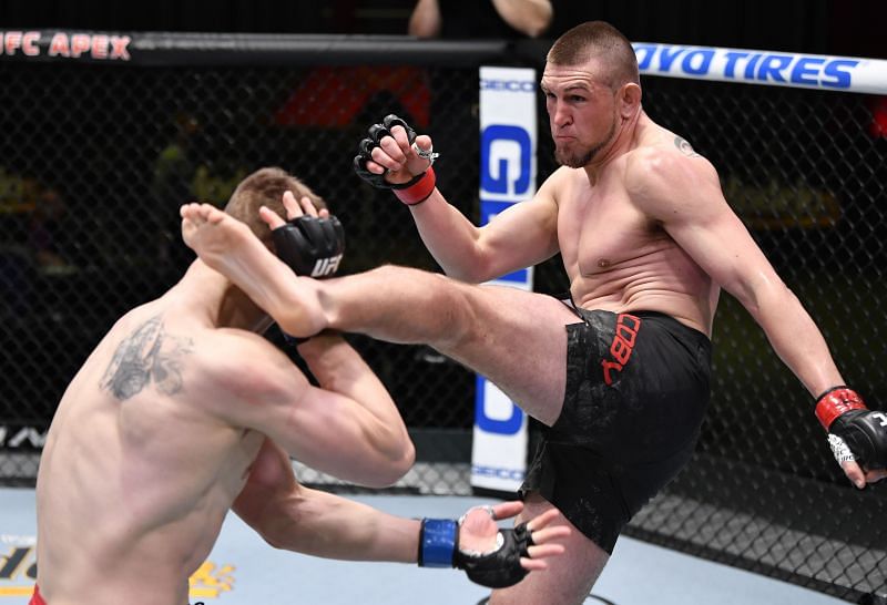 Dustin Jacoby lands a kick against Maxim Grishin