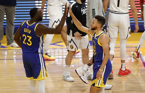 Stephen Curry #30 and Draymond Green #23 congratulate one another during a game