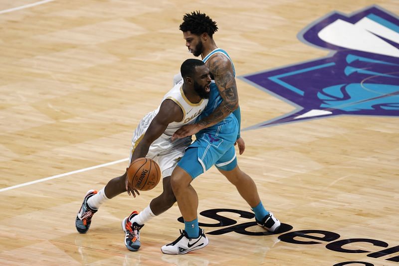 Tim Hardaway Jr. #11 drives to the basket against Miles Bridges #0