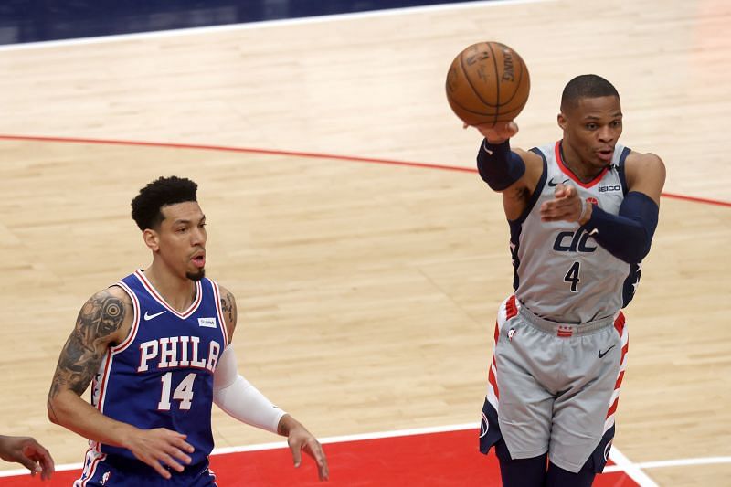 Russell Westbrook #4 passes the ball in front of Danny Green #14.