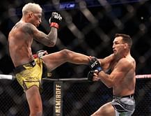 "How in the world are you scoring that 10-8?" - Daniel Cormier compares Charles Oliveira vs Michael Chandler to an infamous UFC fight