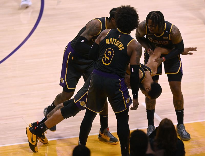 Talen Horton-Tucker #5 of the LA Lakers is helped up by Wesley Matthews #9, Kentavious Caldwell-Pope #1 and Ben McLemore #7