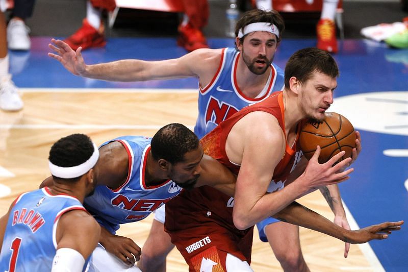 Kevin Durant and Nikola Jokic tussle for the ball