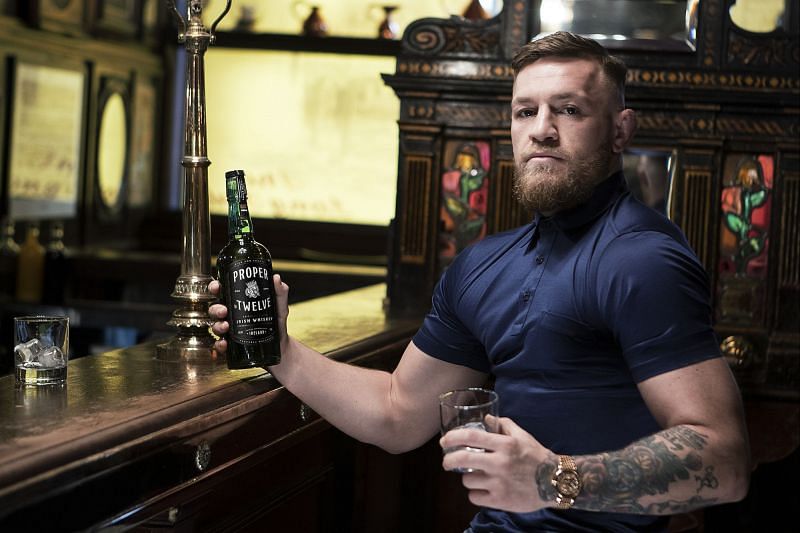 Conor McGregor poses with a bottle of Proper No. Twelve.