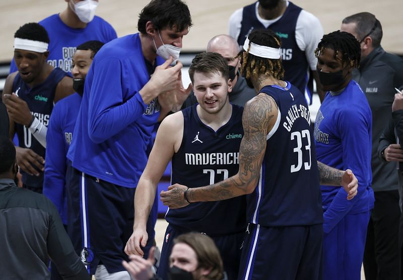 Luka Doncic #77 celebrates with Willie Cauley-Stein #33 after making the game-winning shot against the Boston Celtics