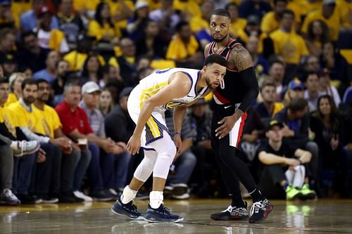 Stephen Curry #30 and Damian Lillard #0 look on during the second half.