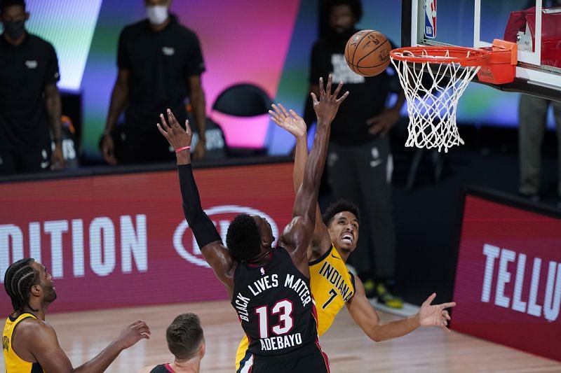 Malcolm Brogdon #7 of the Indiana Pacers has his shot blocked by Bam Adebayo #13 of the Miami Heat.