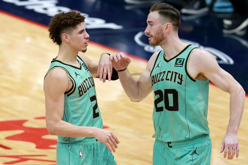 LaMelo Ball #2 and Gordon Hayward #20 have a discussion on the court.
