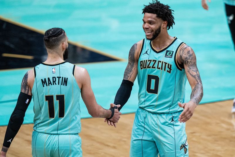 Cody Martin (#11) of the Charlotte Hornets is congratulated by Miles Bridges.