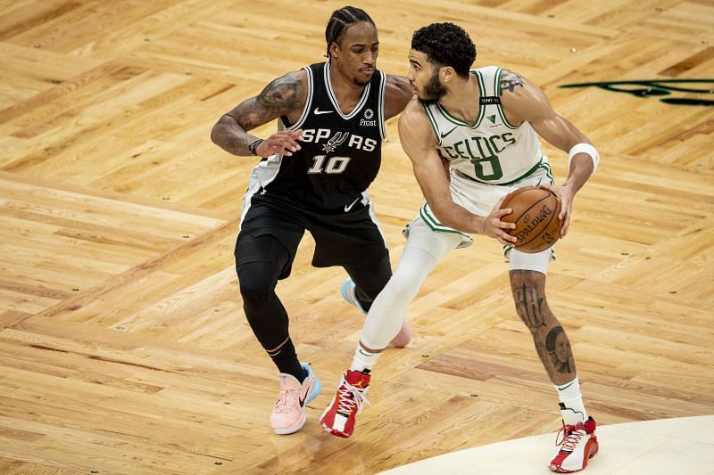 Jayson Tatum of the Boston Celtics protects the ball from DeMar DeRozan of the San Antonio Spurs